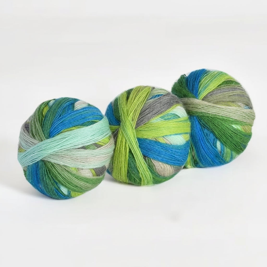 Three skeins of multicolored yarn with a color code and weight label on a white background.