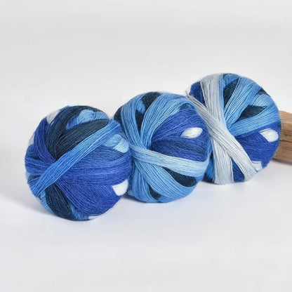Three balls of blue yarn with color code 602 and weight information on a white background.