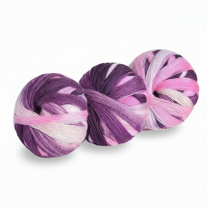 Three skeins of purple and pink yarn on a white background with text indicating color code and weight.